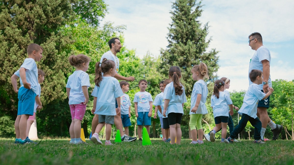a group of young children standing next to each other